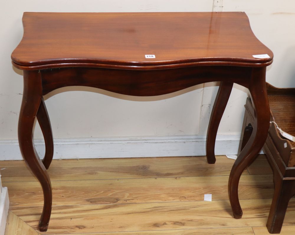 A 19th century French mahogany serpentine folding top tea table, W.86cm
